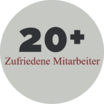 Ein grauer Kreis in dem steht "20+ Zufriedene Mitarbeiter"